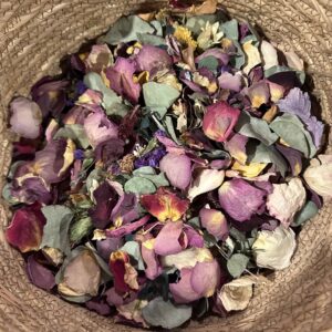 mixed dried flowers in a beige straw basket