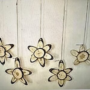 wood slice flowers hanging with jute twine string from a driftwood branch