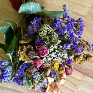 colorful dried flowers in a bouquet on a wood table