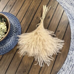 dried pampas grass stem tied in a bouquet on a rustic brown table